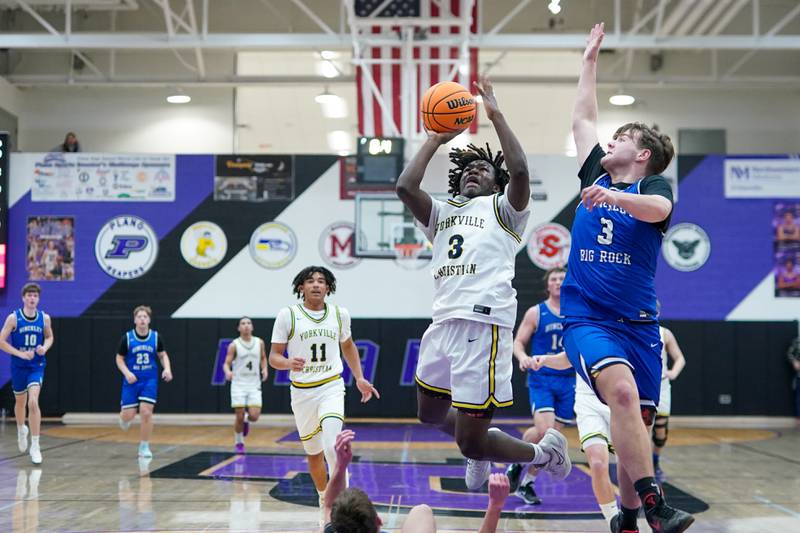 Yorkville Christian's Jayden Riley drives to the basket against Hinckley-Big Rock's Austin Roop during a basketball game in the opening round of the 61st annual Plano Christmas Classic at Plano High School on Monday, December 23, 2024.