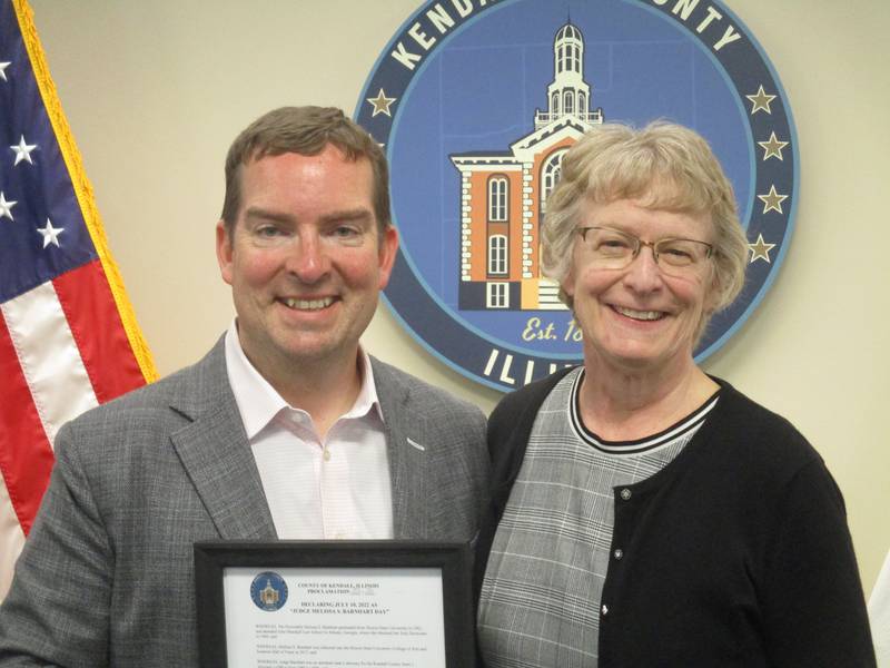 Kendall County Judge Melissa Barnhart, right, is retiring. She was honored by the county board on June 7 and is seen here with board Chairman Scott Gryder. (Mark Foster -- mfoster@shawmedia.com)