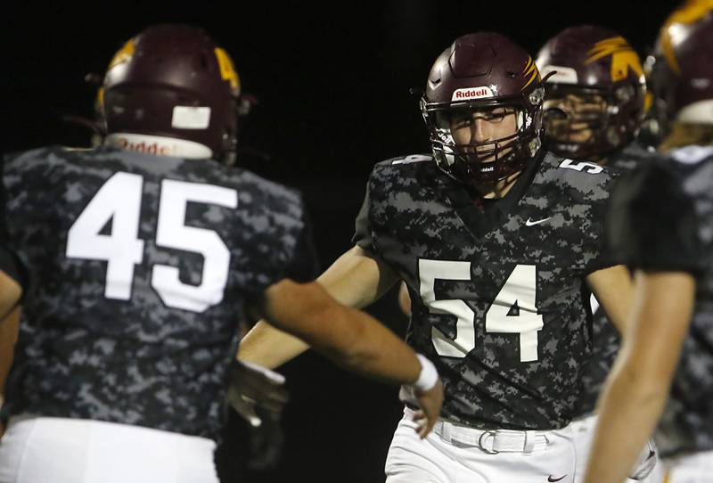 Richmond-Burton's Braxtin Nellessen congratulates Richmond-Burton's Luke Rendtorff (right) after Rendtorff returned an interception for a touchdown during a Kishwaukee River Conference football game on Thursday, Oct.12, 2023, at Richmond-Burton High School.