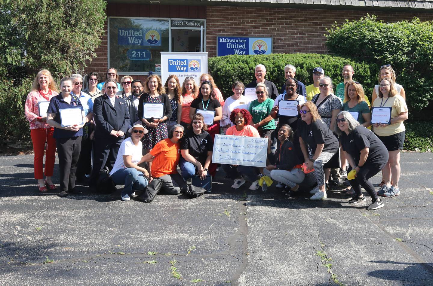 Representatives from funded partner agencies along with the Kishwaukee United Way Board of Directors gather for a photo at their office  Thursday, June 13, 2024, with a check representing the amount of grant allocations by the Kishwaukee United Way this year. Thursday was the Kishwaukee United Way's annual Day of Caring event.