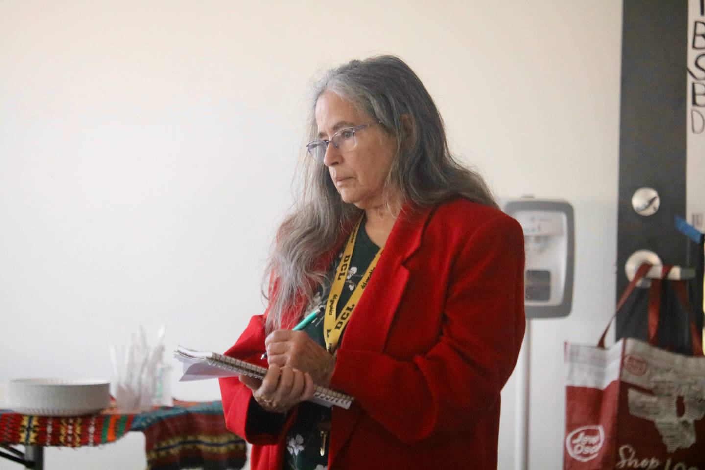 DeKalb County Board member Meryl Domina takes notes Nov. 15, 2025, as she listens to residents' concerns raised during a community meeting held at University Village in DeKalb.
