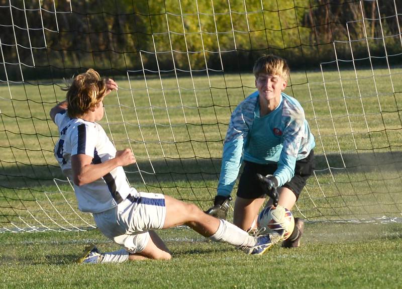 Faith Christian's Landen Cassens lunges for the ball as Oregon goalkeeper Deryk Withers makes the save on Thursday, Oct. 9, 2025 at Oregon Park West.