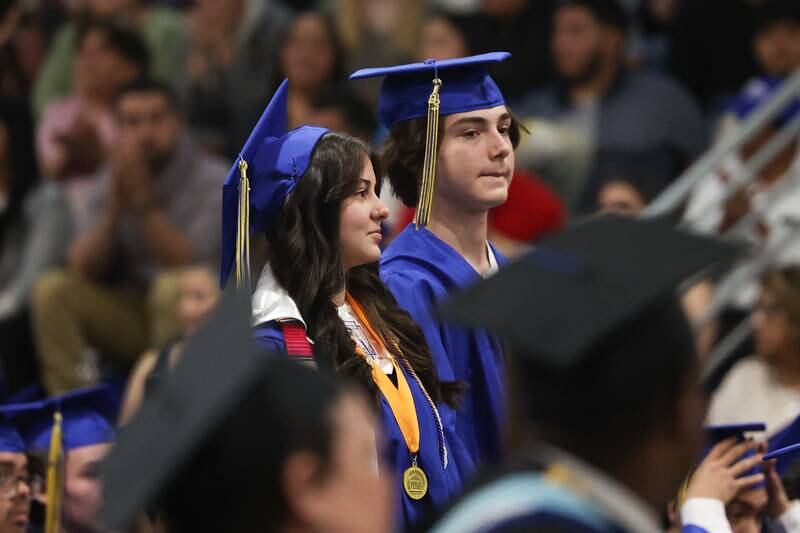 Several graduates stand in recognition at the Joliet Central Class of 2023 Commencement Ceremony on Saturday, May 20, 2023, in Joliet.