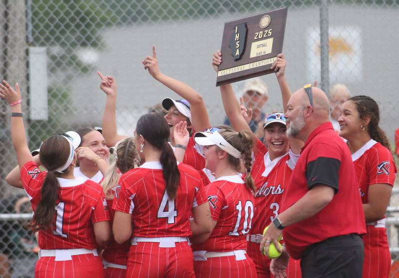 Members of the Bradley-Bourbonnais softball team hoist the Class 4A Supersectional plaque after defeating Edwardsville on Friday, June 6, 2025 at Monticello High School.