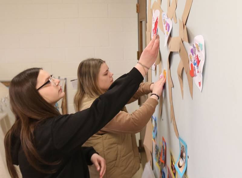 Area Career Center students Brionna Noble and Adriana Buchanan hang pre-school Valentines decorations inside the early childhood classroom on Tuesday, Feb. 11, 2025 at La Sale-Peru Township High School. February is Career and Technical Education (CTE) month.  The month recognizes CTE programs and their contributions to preparing students for college and careers.