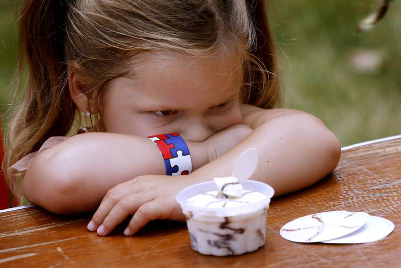 Halo Gregory, 3, of Woodstock, pouts instead of eating ice cream as she competes in the ice cream eating contest during Lakeside Festival Friday, June 30, 2023, at the Dole and Lakeside Arts Park in Crystal Lake. I love the juxtaposition of the joy ice cream brings most people with the willful pouting of Halo.