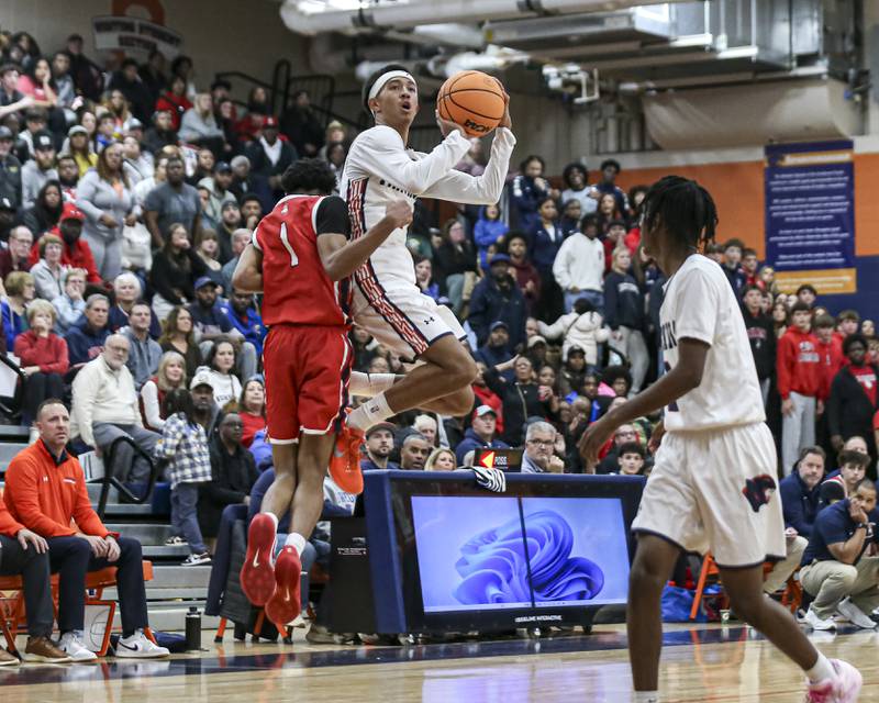 Oswego's Ethan Vahl (3) draws a foul during their basketball game between West Aurora at Oswego Monday, Nov 24, 2025 in Oswego.