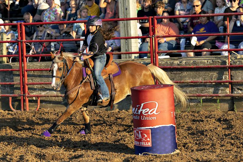 Paisley Hardt competes in the barrel racing event Thursday, August 7, 2025, at Carroll County Fair’s T and A Bucking Bulls Rodeo.