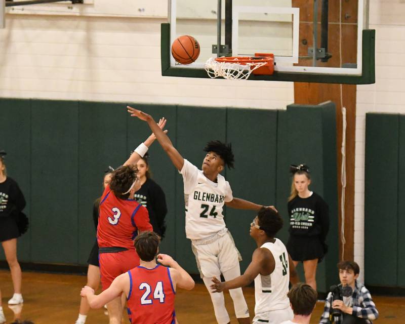 Glenbard South's Angjelos Salca (3) goes up for a shot while being defended by Glenbard West's TJ Williams (24) during the second quarter on Monday Nov. 20, 2023, during the district 87 Invite held at Glenbard West.