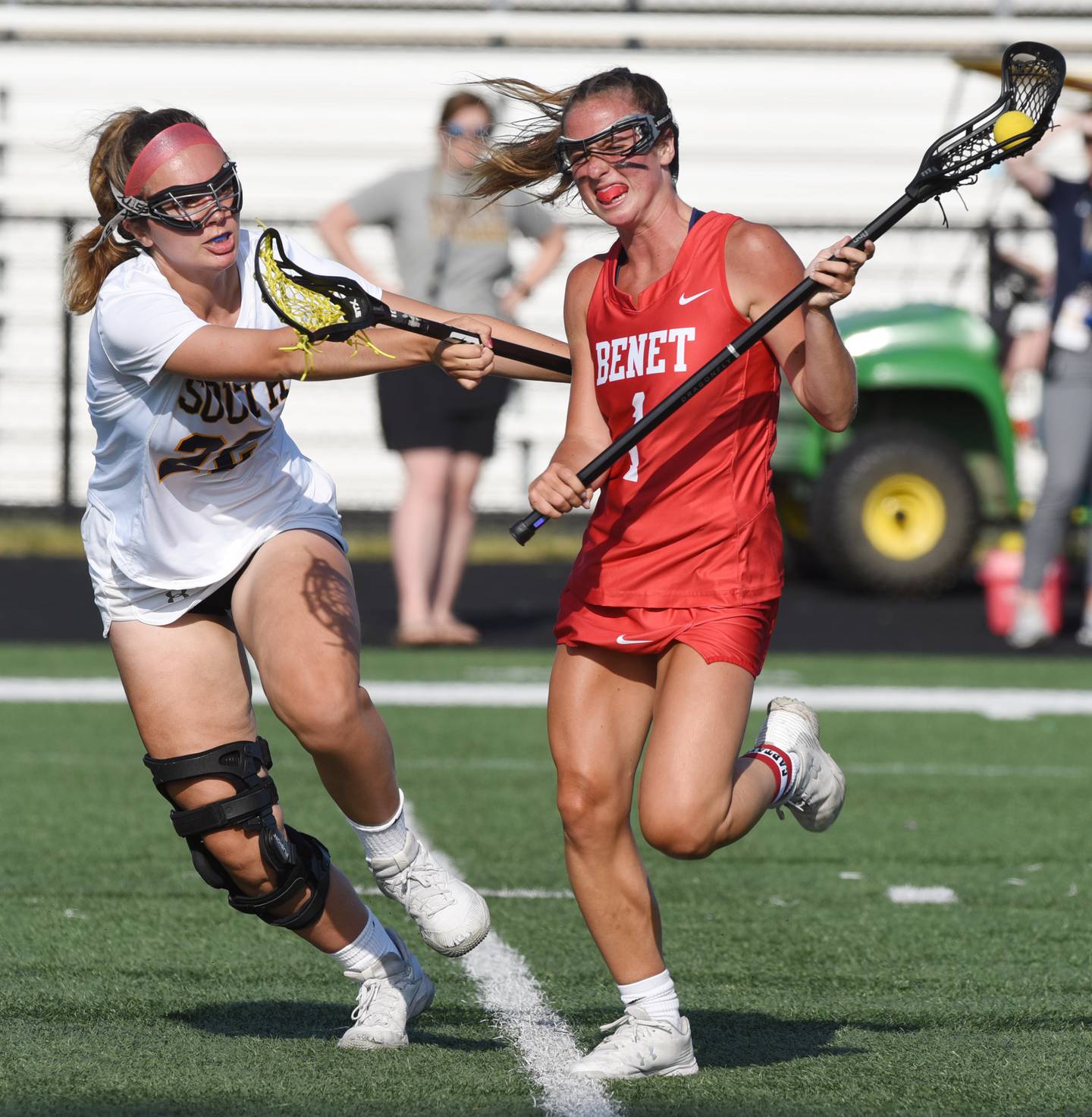 Benet Academy's Karly Keating, right, makes a move past Glenbrook South's Hannah Stettler during the girls lacrosse state semifinal at Glenbrook North High School in Northbrook Thursday.