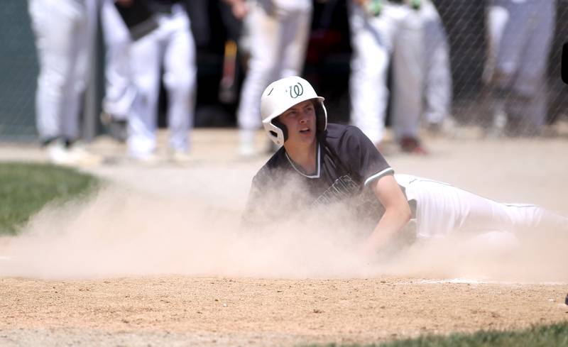 Glenbard West’s Erik Morgan slides into home plate during the Class 4A Glenbard West Regional final against St. Charles East in Glen Ellyn on Saturday, May 28, 2022.