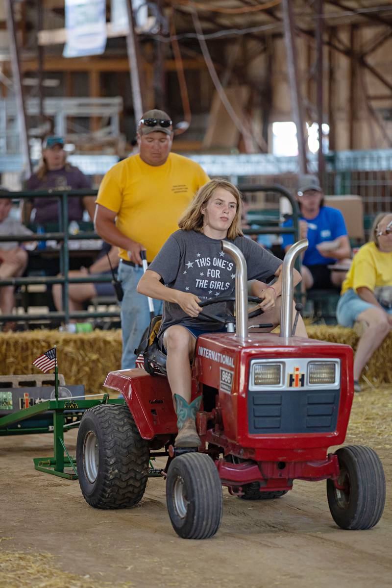 Lexi Sewin of Grand Ridge pushes the throttle in the toy tractor pulling class Sunday, July 31, 2022 during the final day of the Lee County 4H fair in Amboy.