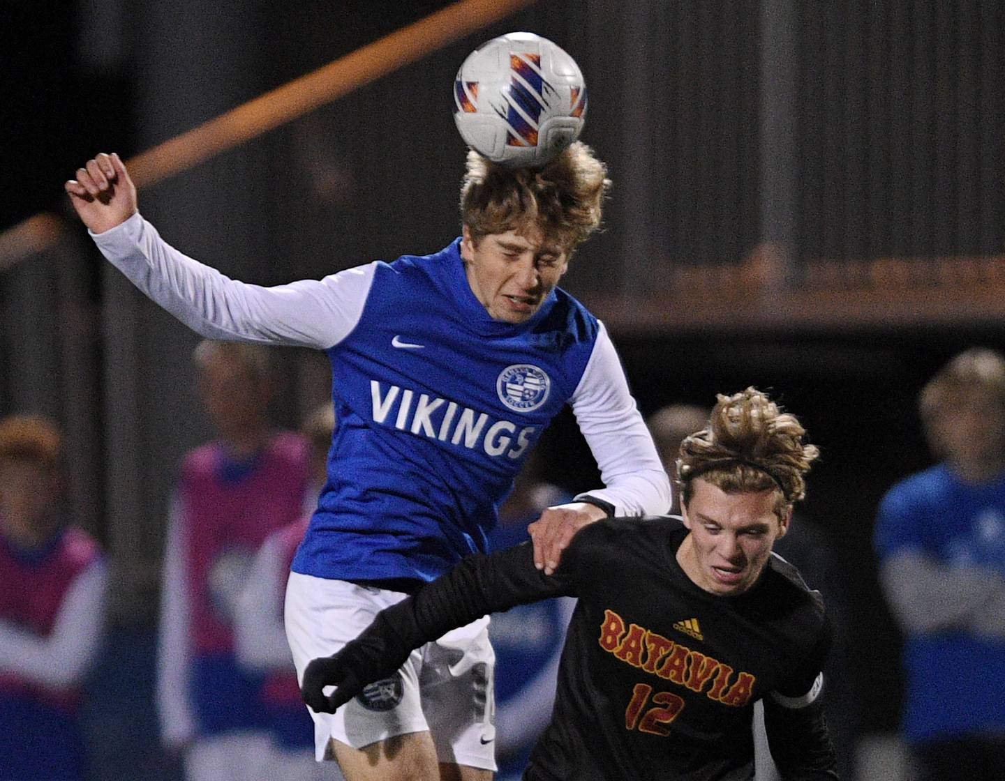John Starks/jstarks@dailyherald.com
Geneva’s Peyton Friedman heads the ball against Batavia’s Nathan Feller in the TriCities boys soccer night game in Geneva on Tuesday, September 27, 2022.