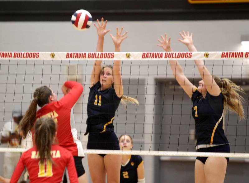 Neuqua Valley’s Eleanor O’Neal (left) and Emi Chiaradonna go up for a block during a game at Batavia on Tuesday, Aug. 29, 2023.