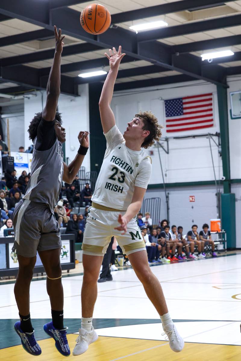 Bishop McNamara's Karter Krutsinger shoots over a Hope Academy defender during the Fightin' Irish's 70-51 loss on Tuesday, Dec. 9, 2025