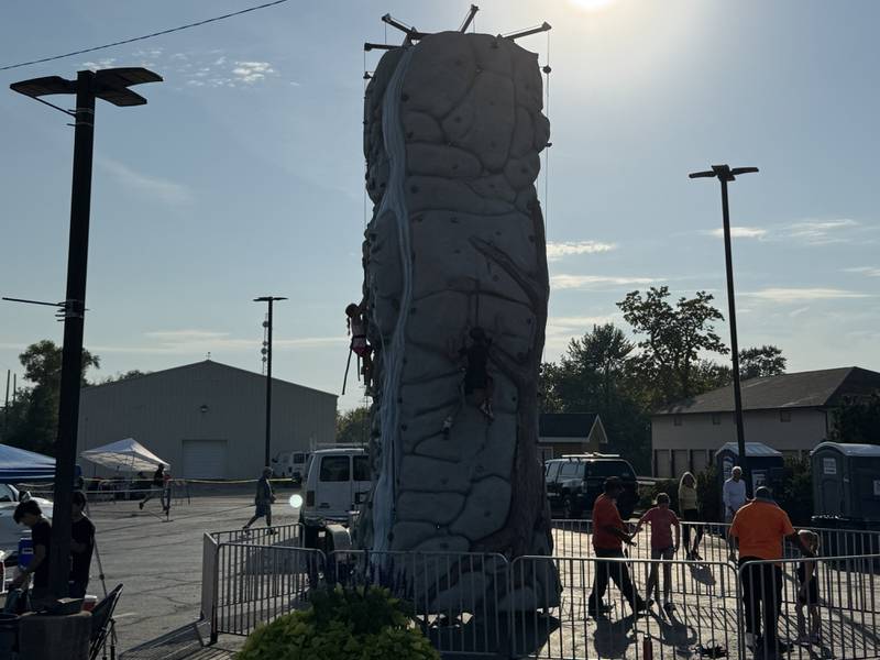 Kids climb the rock wall during Coal City Fall Fest on Saturday, Sept. 13, 2025.