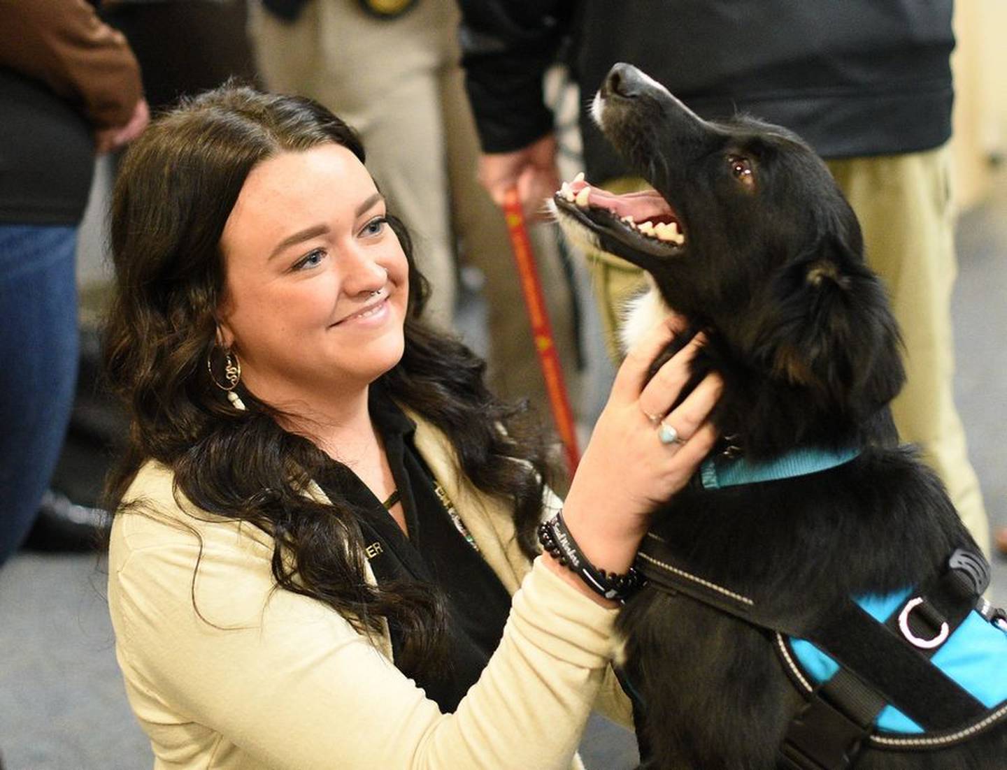 Loki gets some love from one of her handlers, social worker Brenna Russell, Monday before being sworn in as a Kane County sheriff's office therapy dog