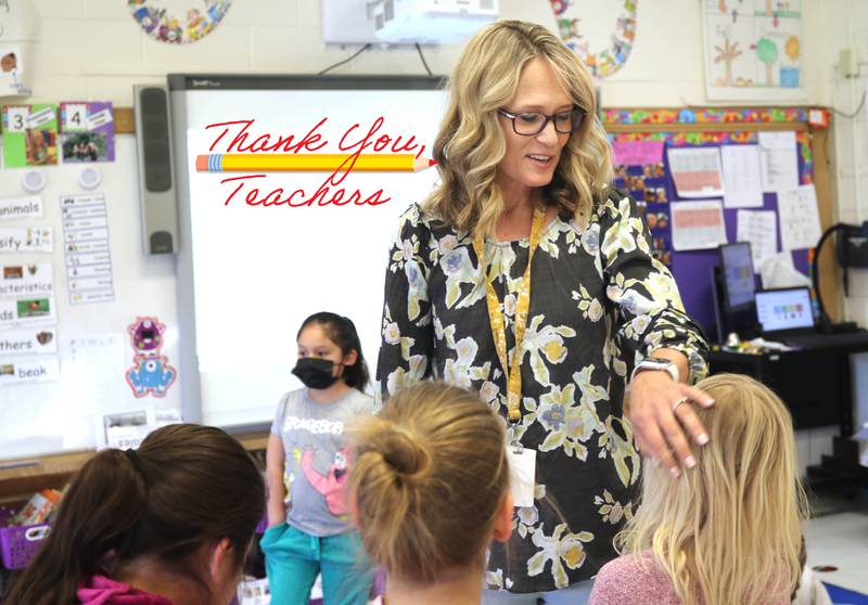 Tracy Paszotta, a kindergarten teacher at Littlejohn Elementary School, welcomes her students back from spring break the morning of Monday, March 28, 2022, at the school in DeKalb.