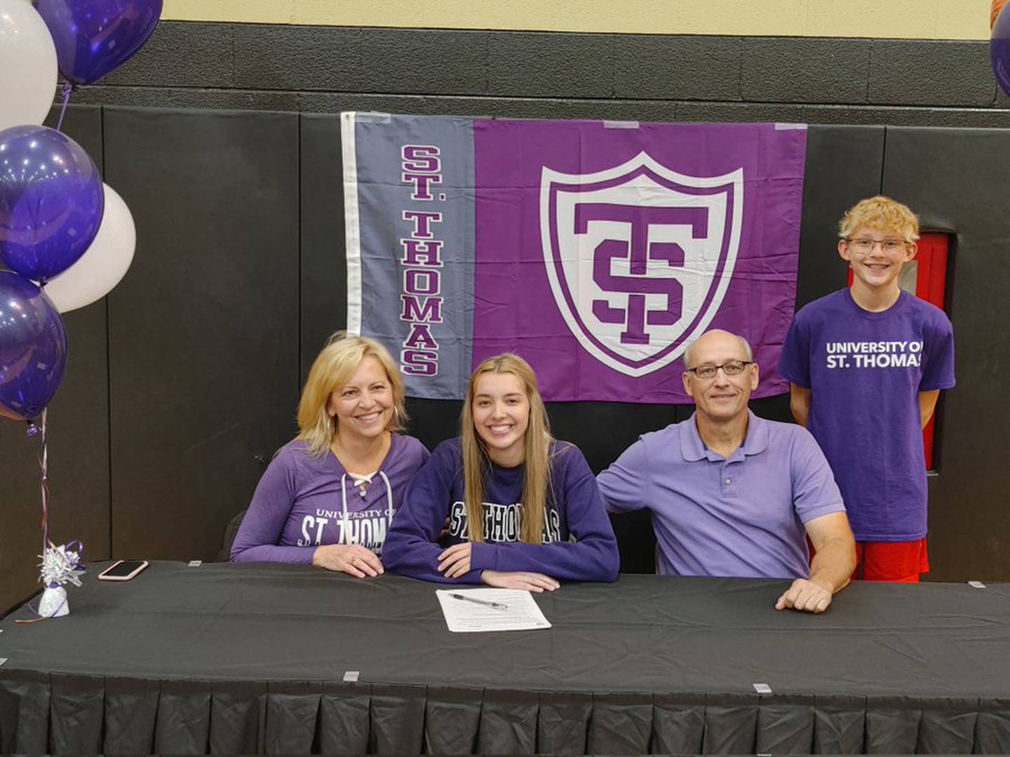 Faith Feuerbach poses with her family after the Sycamore basketball player signed her letter of intent to play for St. Thomas on Wednesday, Nov. 10, 2021.