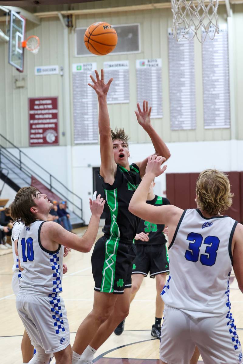 Bishop McNamara's Coen Demack puts up a shot over Clifton Central players  during the Fightin' Irish's 62-41 victory in the Watseka Holiday Tournament championship on Tuesday, Dec. 16, 2025.