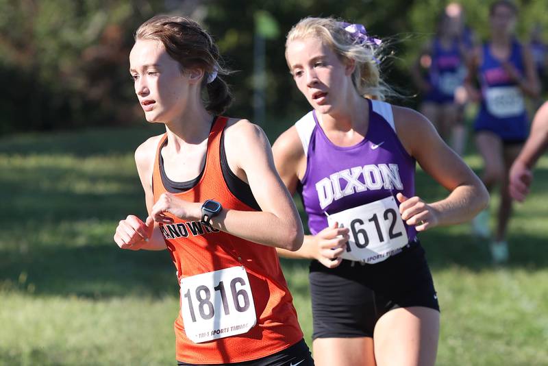 Sandwich's Sundara Weber leads the girls race around a turn just ahead of Dixon's Emma Smith Tuesday, Aug. 30, 2022, during the Sycamore Cross Country Invitational at Kishwaukee College in Malta.