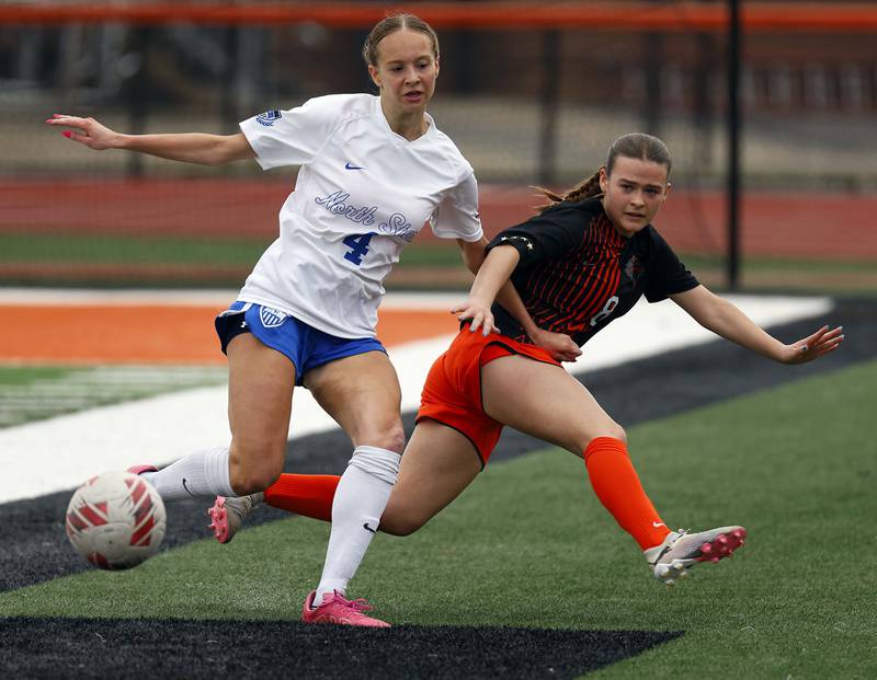 St. Charles North's Kaitlyn Nudera (4) and St. Charles East's Georgia Smith (8) collide as the trie to control the ball during the championship game of the Rose Augsburg Drach Invitational Saturday, March 29, 2025 in St. Charles Ill.