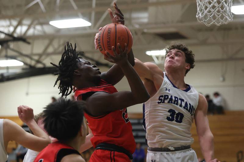 Bolingbrook’s Jason Lawani draws the shooting foul against St. Francis’ Gavin Mueller in the Jack Tosh 2023 Holiday Classic on Wednesday, Dec.27th, 2023 in York.