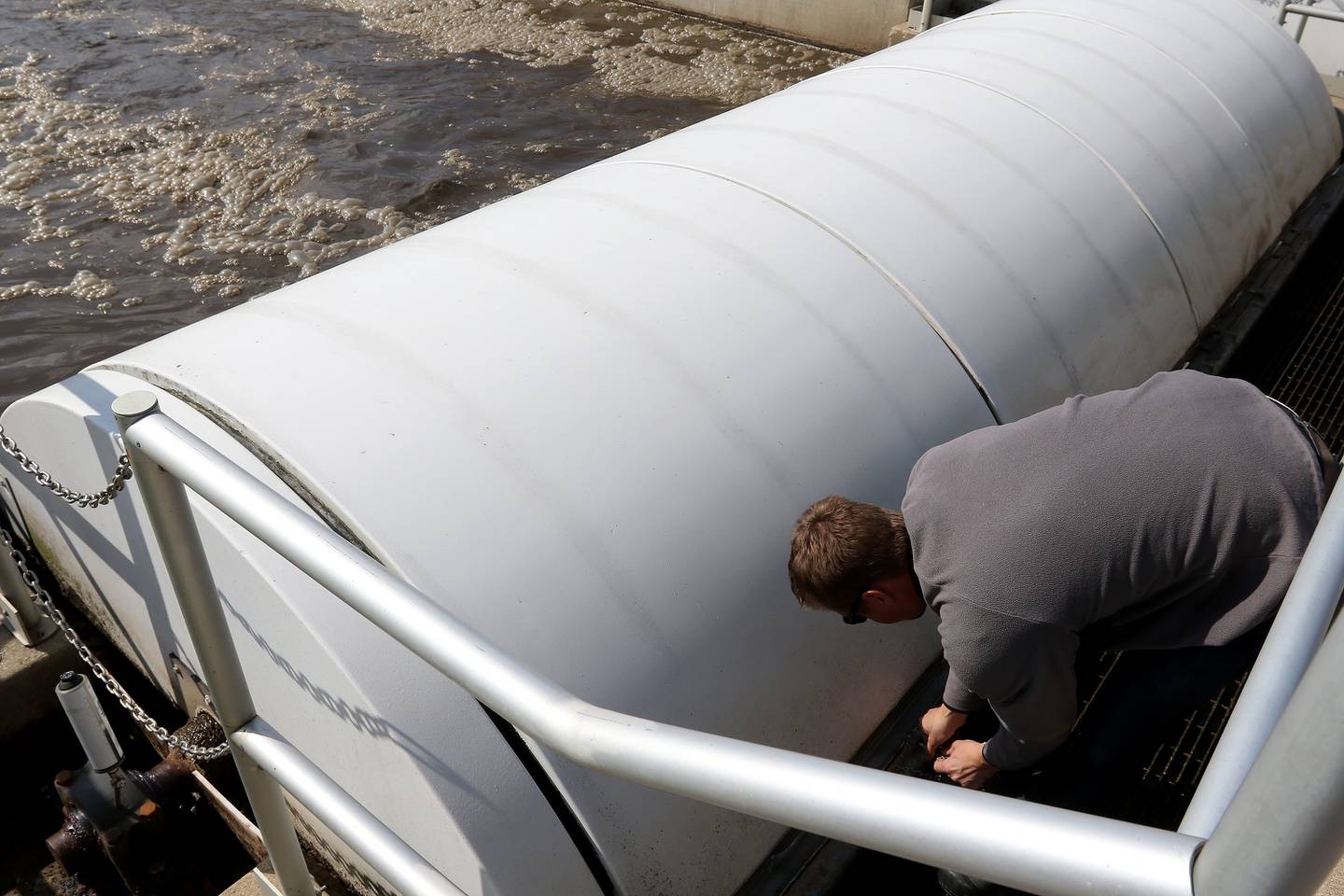 Northern Moraine Wastewater Reclamation District Superintendent Luke Markko opens a covered section in an aeration tank at the wastewater treatment plant on Thursday, April 22, 2021, in Island Lake. The district is attempting to build a sewer for the village of Holiday Hills.