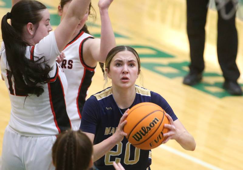 Marquette's Kaitlyn Davis works her way into the lane to score against Amboy/Ohio during the Class 1A Regional championship on Thursday, Feb. 20, 2025 at St. Bede Academy.
