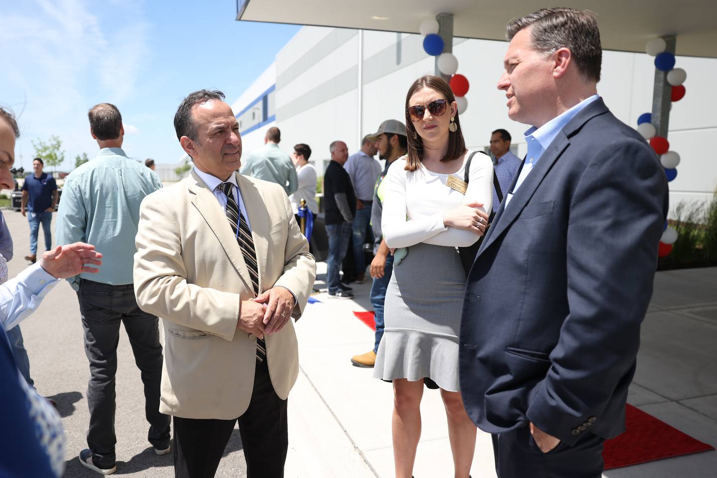 Joliet Economic Development Director Cesar Suarez, left, speaks with Will County Center for Economic Development representatives Kayla Sorensen and Doug Pryor at the ribbon cutting ceremony for the new Harbor Freight distribution facility in Joliet. Harbor Freight opened a new 1.6 million square-foot distribution center in Joliet that is expected to bring 800 new jobs to the area. Thursday, June 9, 2022 in Joliet.