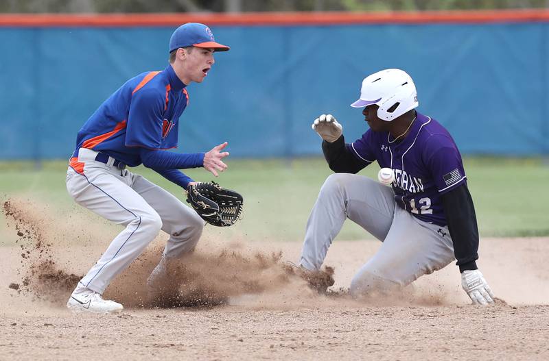 Genoa-Kingston's Connor Grimm takes the throw as Rockford Lutheran's Kyng Hughes slides in with a stolen base during their game Tuesday, May 2, 2023, at Genoa-Kingston High School.