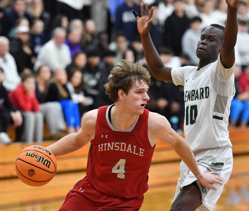 Hinsdale Central’s Vincas Buzelis (4) drives past Glenbard West’s Josh Abushanab during a game on January 31, 2025 at Glenbard West High School in Glen Ellyn.