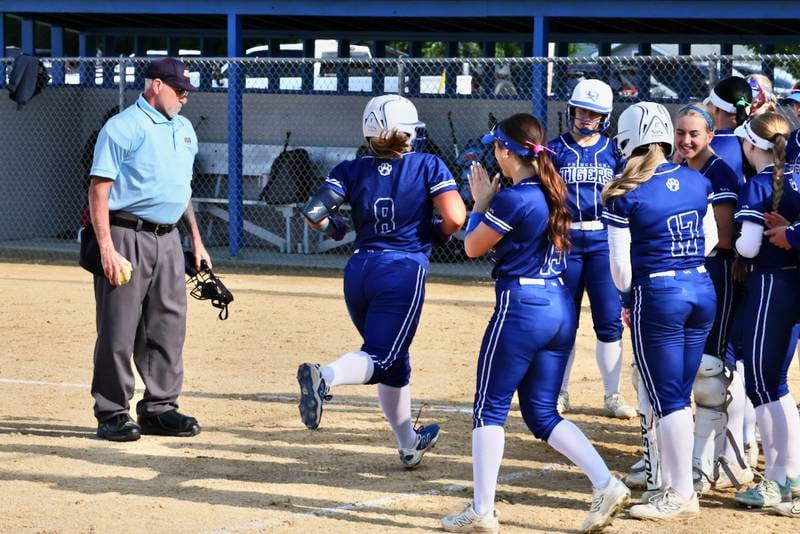 Princeton's Avah Oertel (8) is greeted at home plate by her teammates after hitting a home run during the Tigresses' 15-0, four-inning victory on Thursday, May 7, 2026 in Princeton.