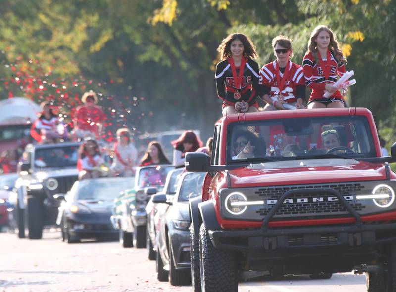 Hall sophomore attendants Evelyn Bryant, Jamie Jablonski and Aubrey Merkel ride in the Hall High School Homecoming parade on Thursday, Sept. 28, 2023 in Spring Valley.