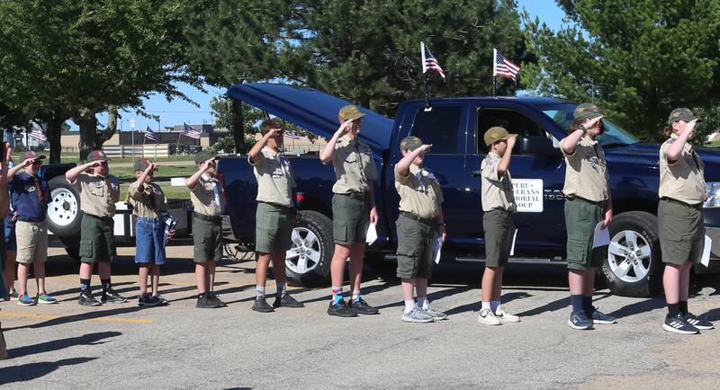 Boyscout from Troop 123 and Cub Scouts Pack 3709 salute an American Flag  during a Flag Retirement Ceremony on Friday, June 14, 2024 at Veterans Park in Peru.  The ceremony always takes place on Flag Day. It began as a Eagle Scout project for area boy scouts about 30 years ago. When an American Flag gets torn and tattered, Flag etiquette requires it to be proper disposed in a burning cauldron.
