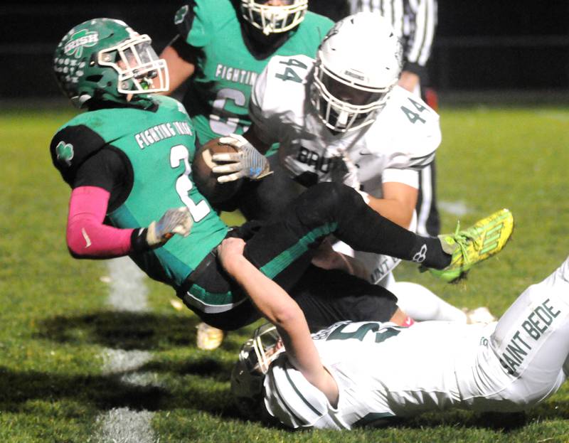 Seneca's Asher Hamby is tackled by St. Bede's Ruby Michels (44) and Garrett Connelly at Seneca on Friday, Oct. 20, 2023.
