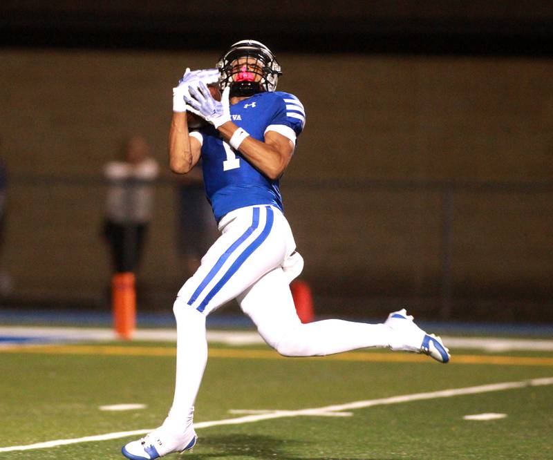 Geneva’s Talyn Taylor makes a catch before running it in for a touchdown during a game against Wheaton North on Friday, Oct. 11, 2024 in Geneva.