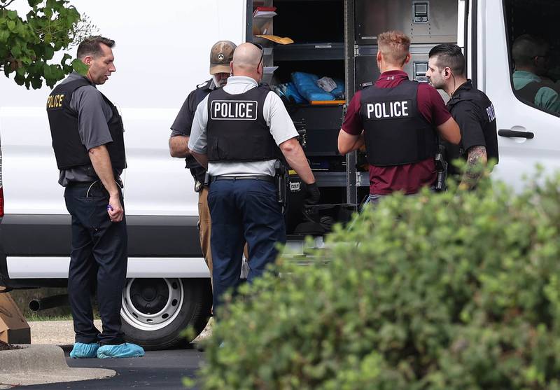 DeKalb police officers gather outside the Illinois Community Credit Union Wednesday, July 31, 2024, as they investigate a morning bank robbery in the facility at 1500 Barber Greene Road in DeKalb.