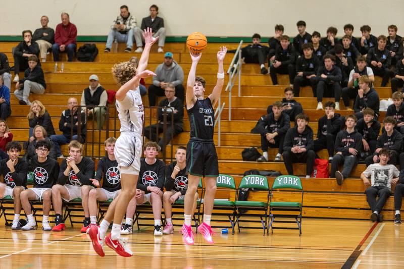 Glenbard West's Bennett Kammes shoots a three pointer over Yorkville's Graham Martinson on Friday Dec. 26,2025 at the 51st. Annual Jack Tosh Holiday Tournament in Elmhurst.