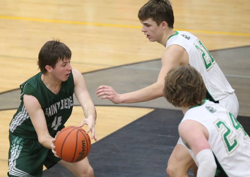St. Bede's Logan Potthff is stuck in the lane as he is met by Seneca's Lane Provance and teammate Grant Siegel during the Tri-County Conference Tournament on Tuesday, Jan. 23, 2024 at Putnam County High School.