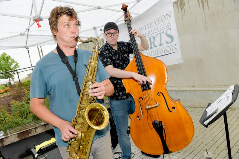 Trever Hill and Glen O’Fallon of Trever Hill’s Beyond Standard Group perform at the Fine and Cultural Arts Commission’s Andy Warhol’s birthday celebration at the Wheaton French Market on Saturday, August 5, 2023.