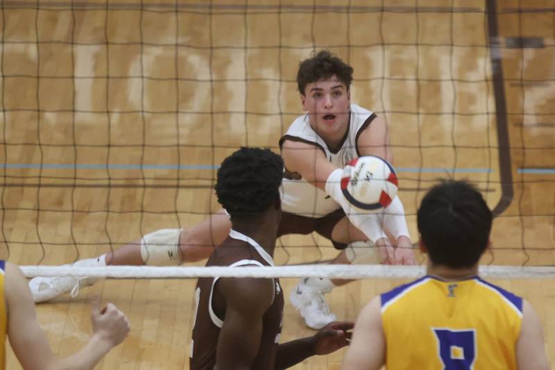 Joliet Catholic’s Benjamin Alessio digs a shot against Joliet Central on Wednesday, April 1, 2026 in Joliet.