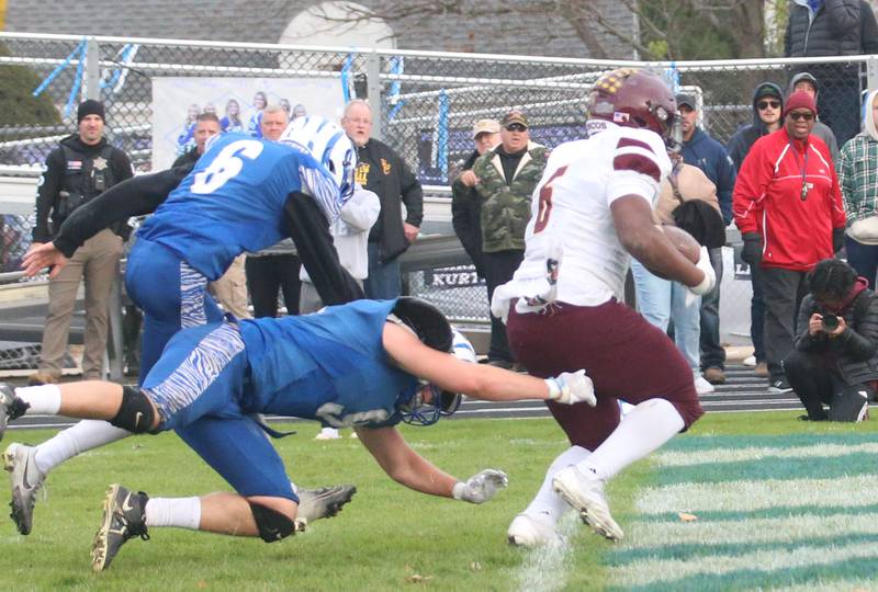 Montini Catholic's Jeremiah Peterson runs the ball in for a touchdown against Princeton's Arthur Burden and teammate Jaydon Cooke during the Class 3A quarterfinal game on Saturday, Nov. 16, 2024 at Bryant Field in Princeton.
