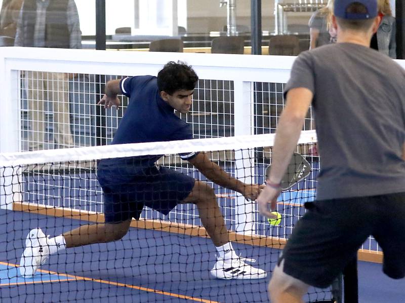 Ammar Wazir hits the ball while playing pickleball with Andres Graczyk during a grand opening ceremony for the Pickle Haus in Algonquin, on Friday, Nov. 10, 2023. The Pickle Haus offers indoor pickleball courts, food and drinks.