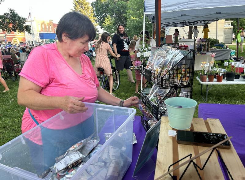 Jane Koeller of Gramma's Sweet Treats of Forreston restocks her booth at the Mt. Morris Jamboree on Friday, June 20, 2025. In addition to the free music, the concert series includes vendor and food booths on the Campus in downtown Mt. Morris Friday nights through the summer.
