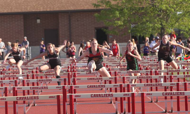 (From left) Kaneland's Allison Curth and teammate Olivia Pastovich, L-P's Elli Sines and teammate Aubrey Duttlinger and Sycamore's Tayor Olson compete in the 100 meter hurdles during the Interstate 8 conference track meet on Friday, May 3, 2024 at the L-P Athletic Complex in La Salle.