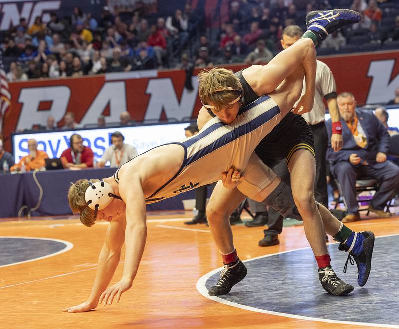 Newman’s Briar Ivey (left) and Riverdale’s Blake Smith compete in the 157 pound weight class of the 1A state individual wrestling finals Saturday, Feb. 22, 2025, at State Farm Center in Champaign.