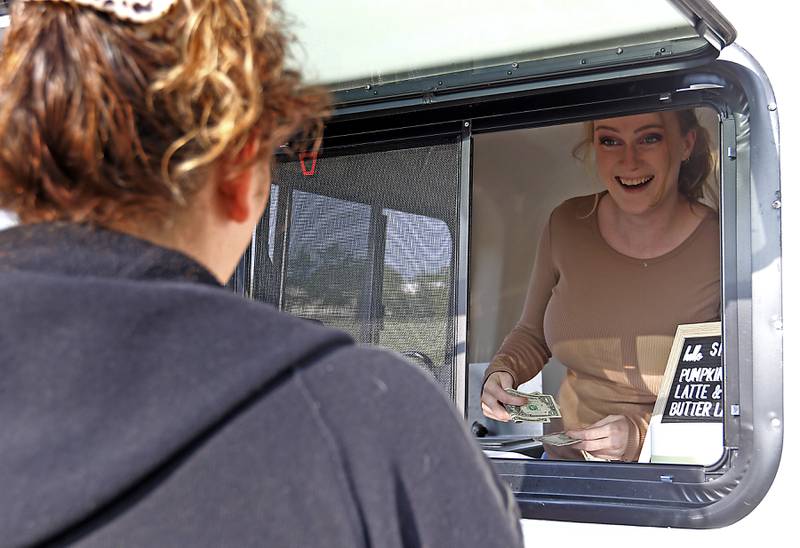 Johnsburg resident Erika Kosick, who started her small business Erika's Odd Coffee recently, talks with customer Kasia Bussan as she sells coffee Thursday, Aug. 22, 2024, from her pop-up trailer in the parking lot of Northbound Fitness Club in Spring Grove. She will also be a vendor at the Johnsburg and Spring Grove farmers markets.