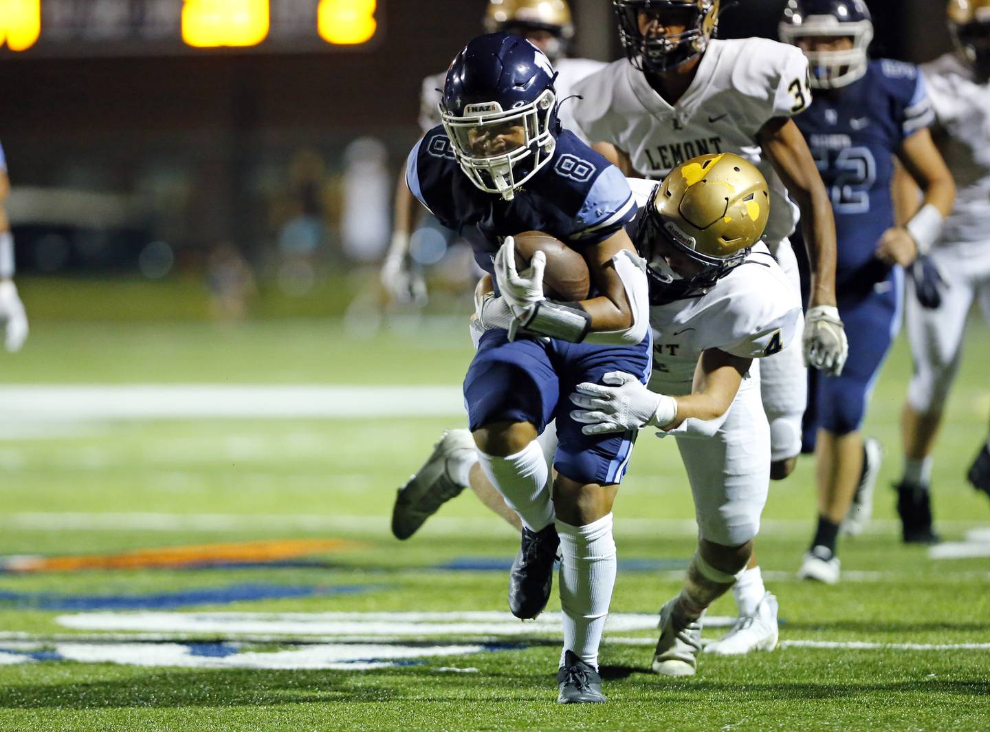 Nazareth Academy's Ethan Enriquez (8) is tackled during the boys varsity football game between Lemont High School and Nazareth Academy on Friday, Sept. 2, 2022 in LaGrange, IL.