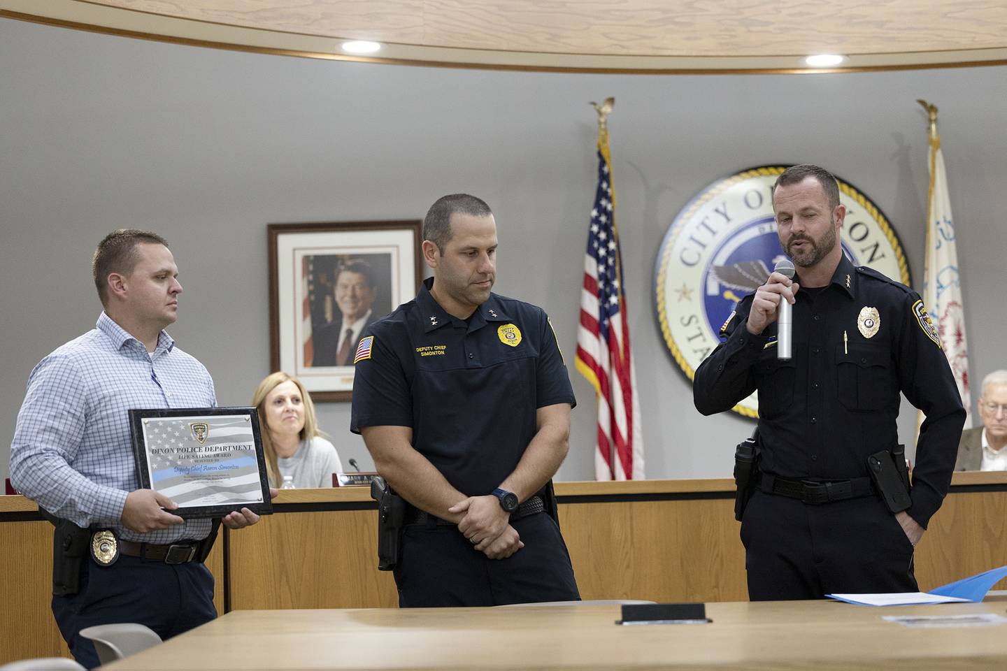 Dixon Police Chief Ryan Bivins (right) announces during the Monday, Nov. 3, 2025, Dixon City Council meeting that Deputy Chief Aaron Simonton (middle) is receiving the Life Saving Award for helping a choking man while out of town recently. Simonton administered the Heimlich while at a restaurant.